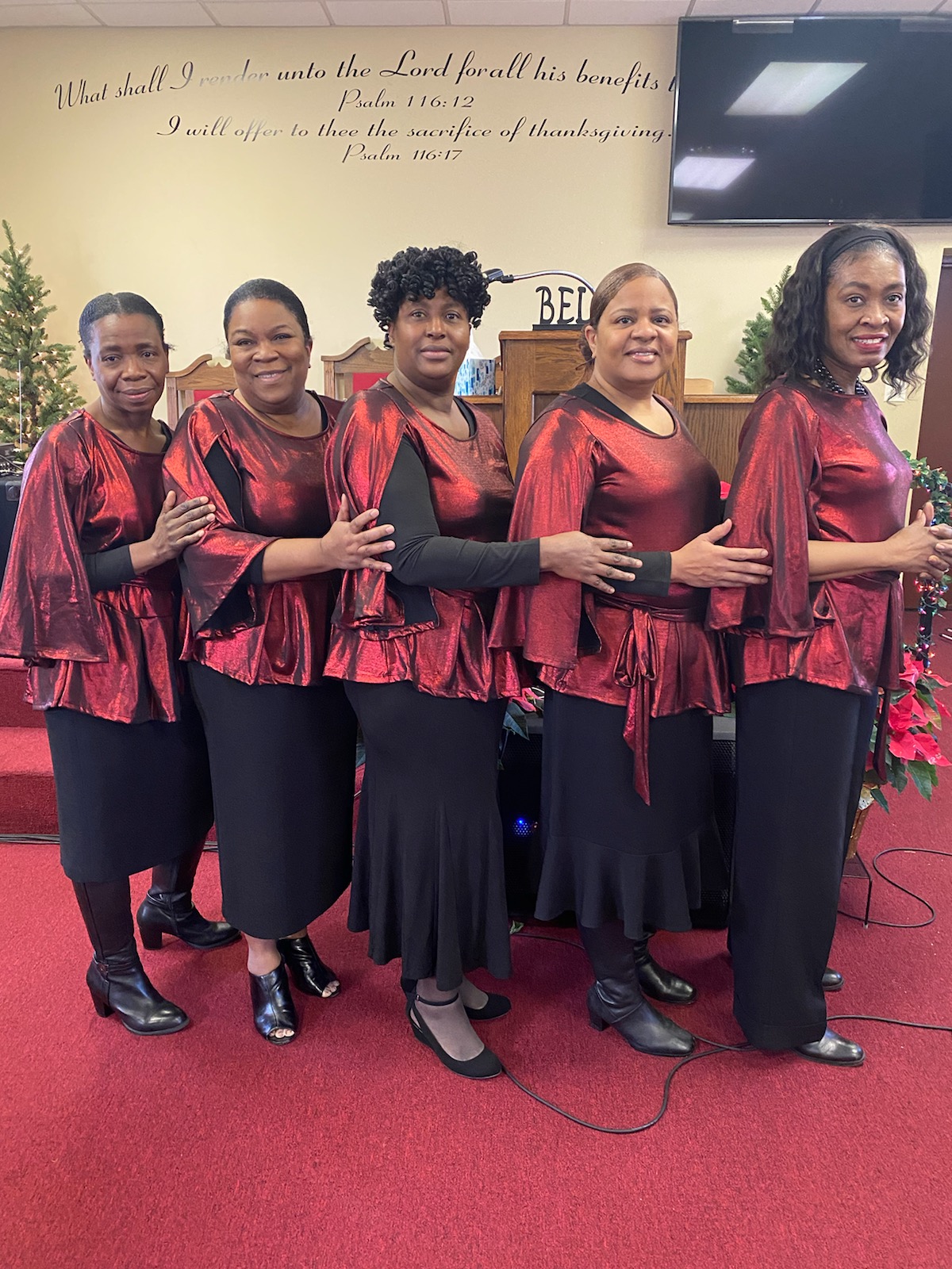 Women's ministry standing together before the altar