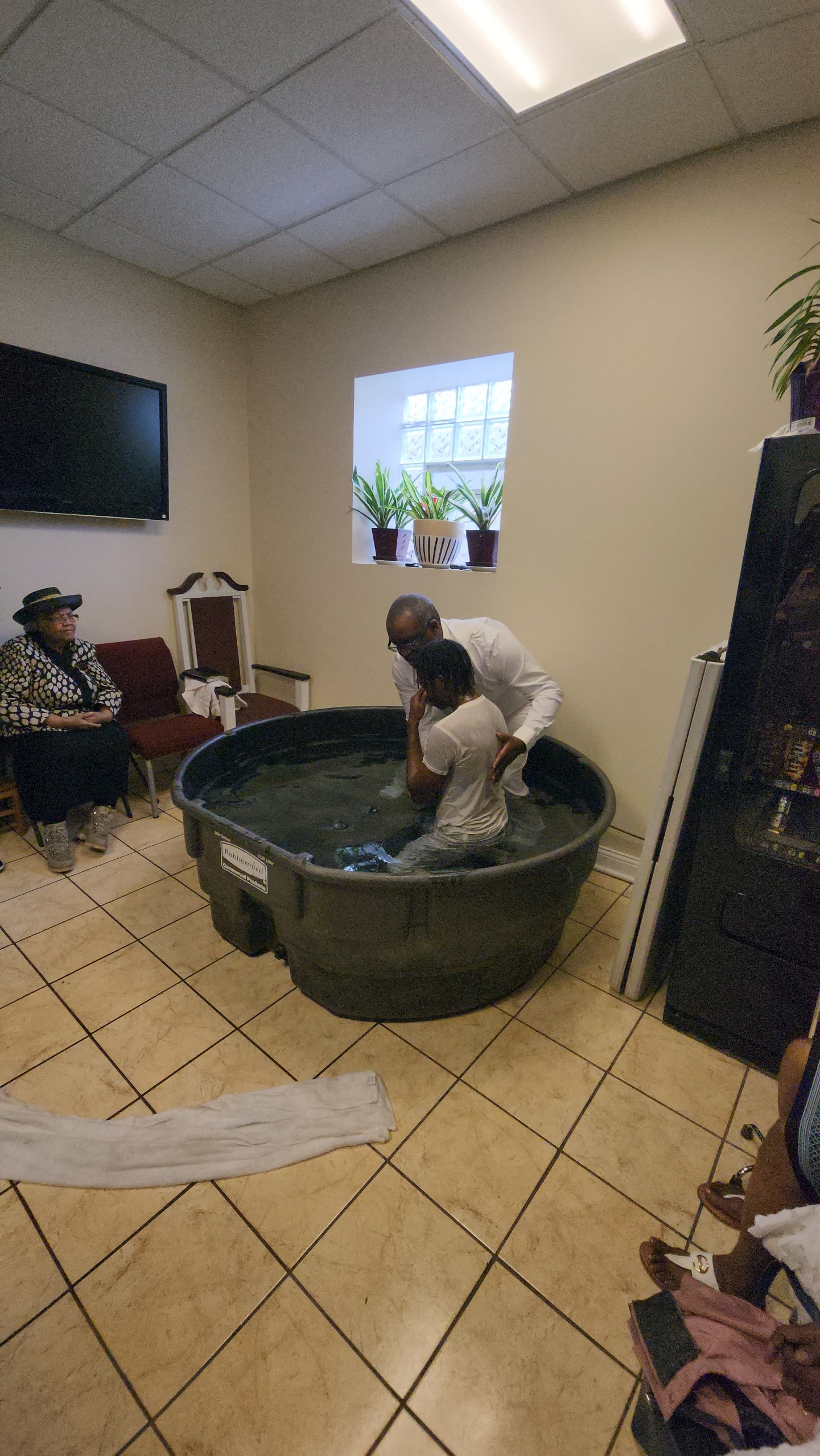 A believer being baptized at New Jerusalem